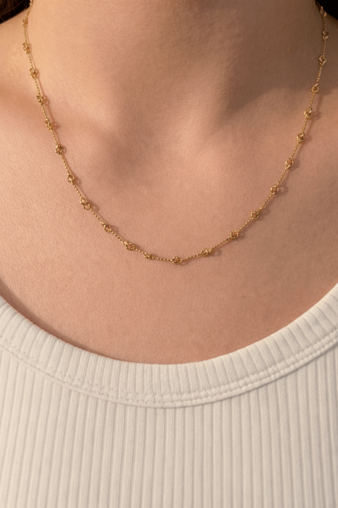 delicate gold beaded chain necklace with subtle details worn on neck