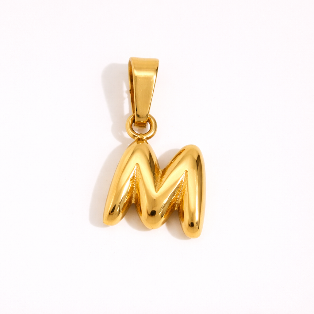 Gold letter M charm pendant with smooth rounded finish