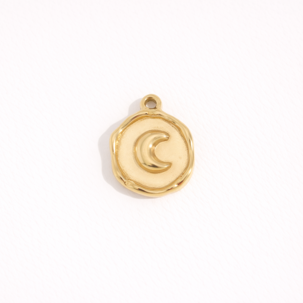 Round gold charm pendant with crescent moon embossed design