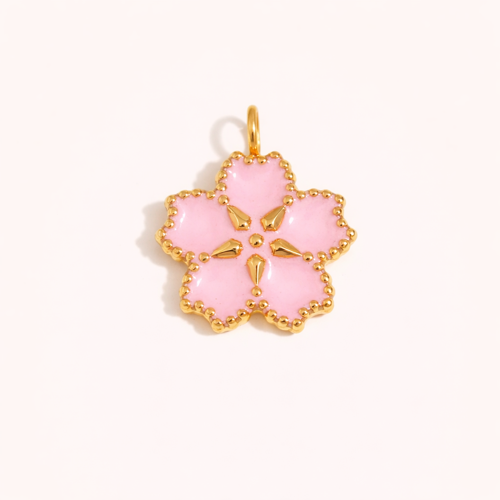 Pink enamel flower shaped gold charm with beaded edge detail