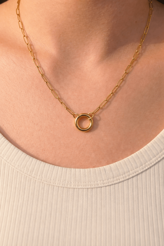 gold chain necklace with ring connector worn on the neck